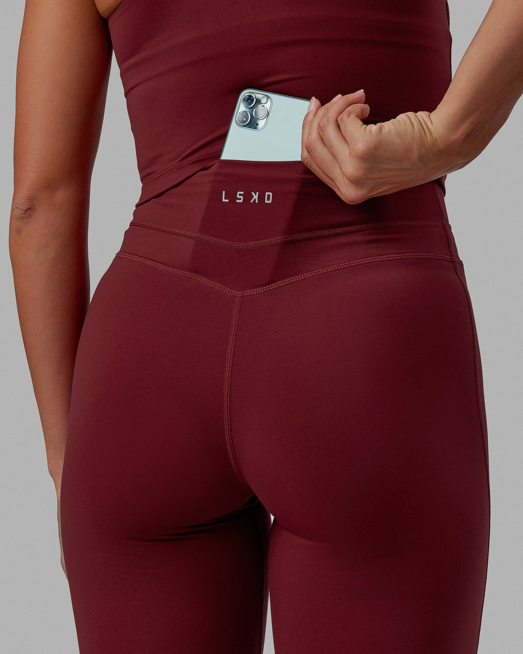 Woman wearing Enhance Full Length Tights - Cranberry