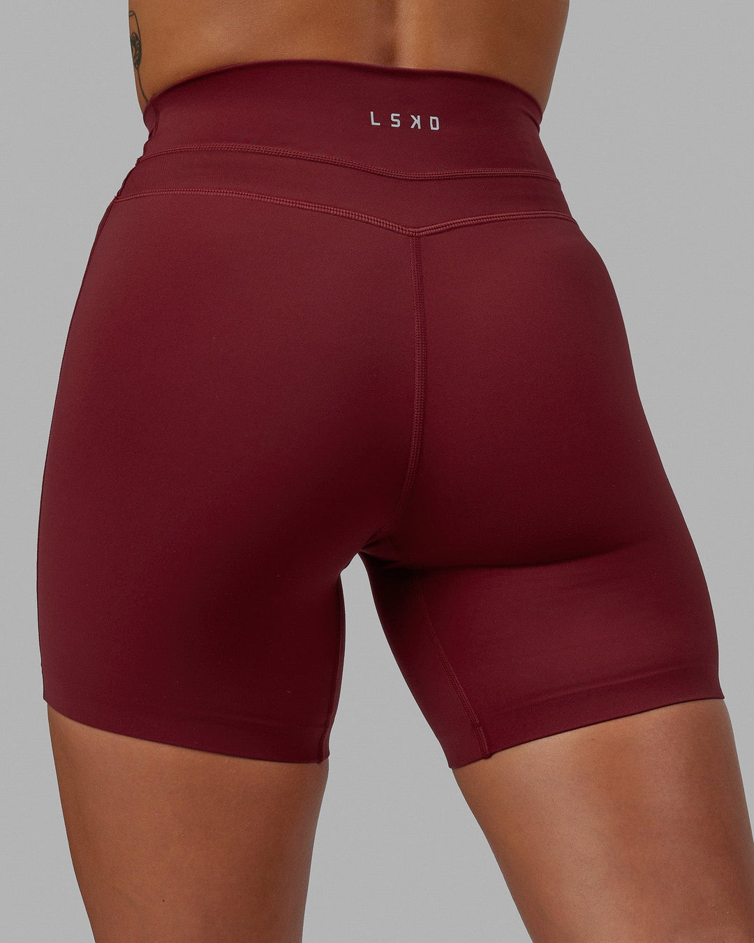 Woman wearing Enhance Mid Short Tights - Cranberry