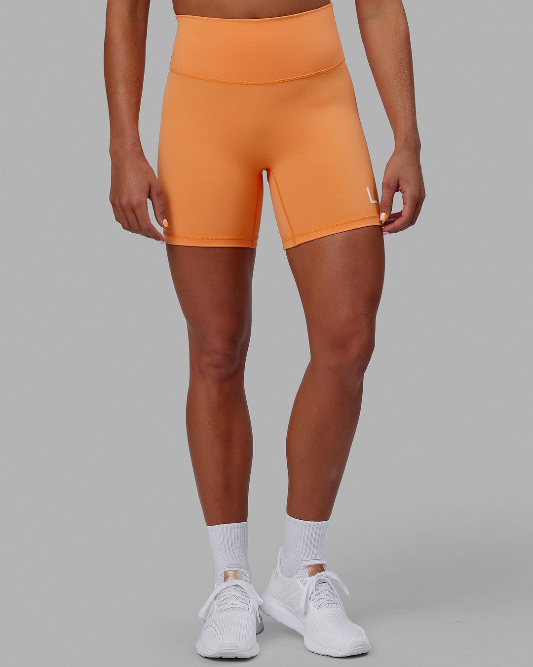 Woman wearing Evolved Mid Short Tight - Tangerine