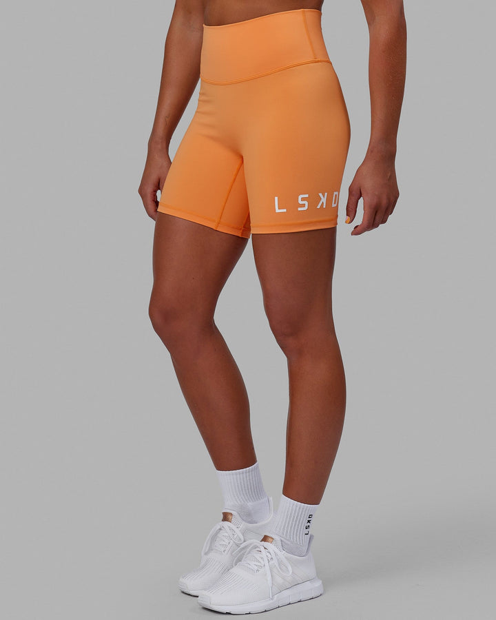 Woman wearing Evolved Mid Short Tight - Tangerine