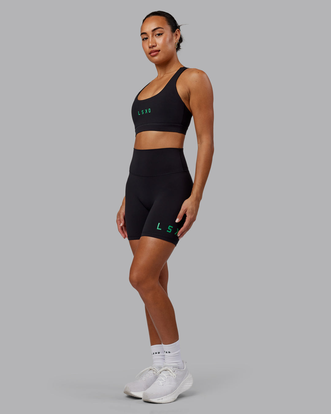 Woman wearing Evolved Ultra High-Rise 6&quot; Short - Black-Impact Green