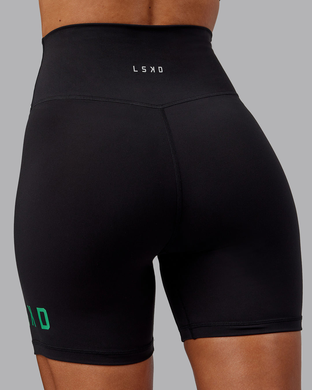 Woman wearing Evolved Ultra High-Rise 6&quot; Short - Black-Impact Green