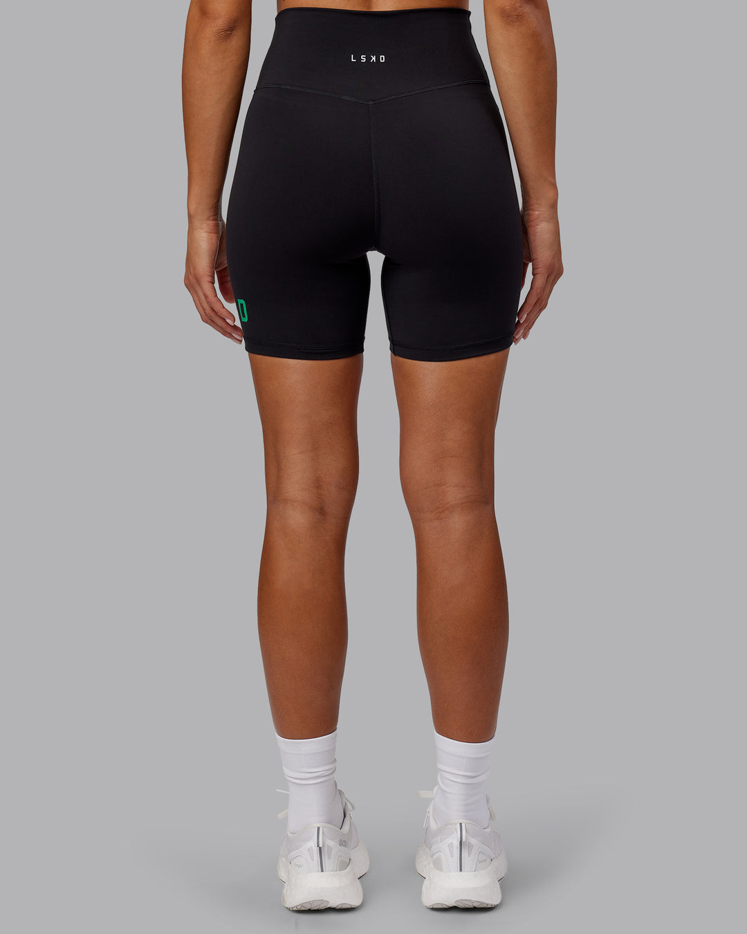 Woman wearing Evolved Ultra High-Rise 6&quot; Short - Black-Impact Green