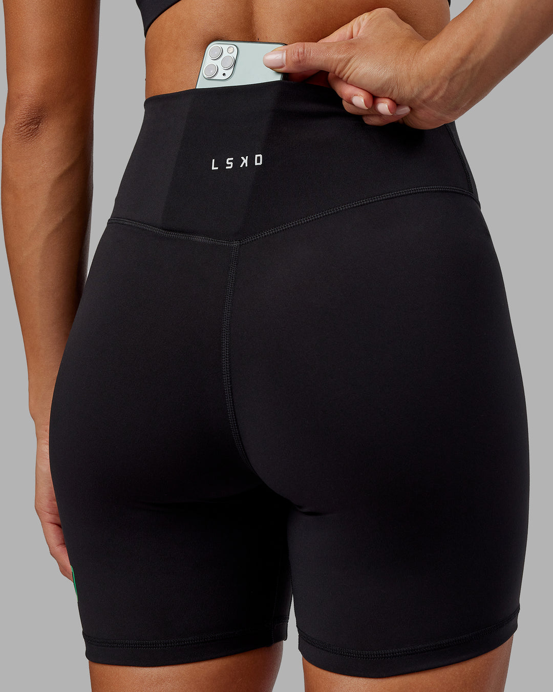 Woman wearing Evolved Ultra High-Rise 6&quot; Short - Black-Impact Green