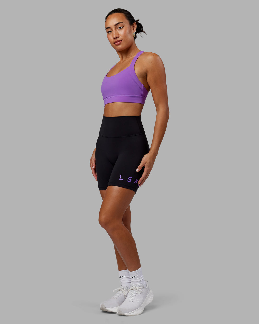 Woman wearing Evolved Ultra High-Rise 6&quot; Short - Black-Purple Swirl