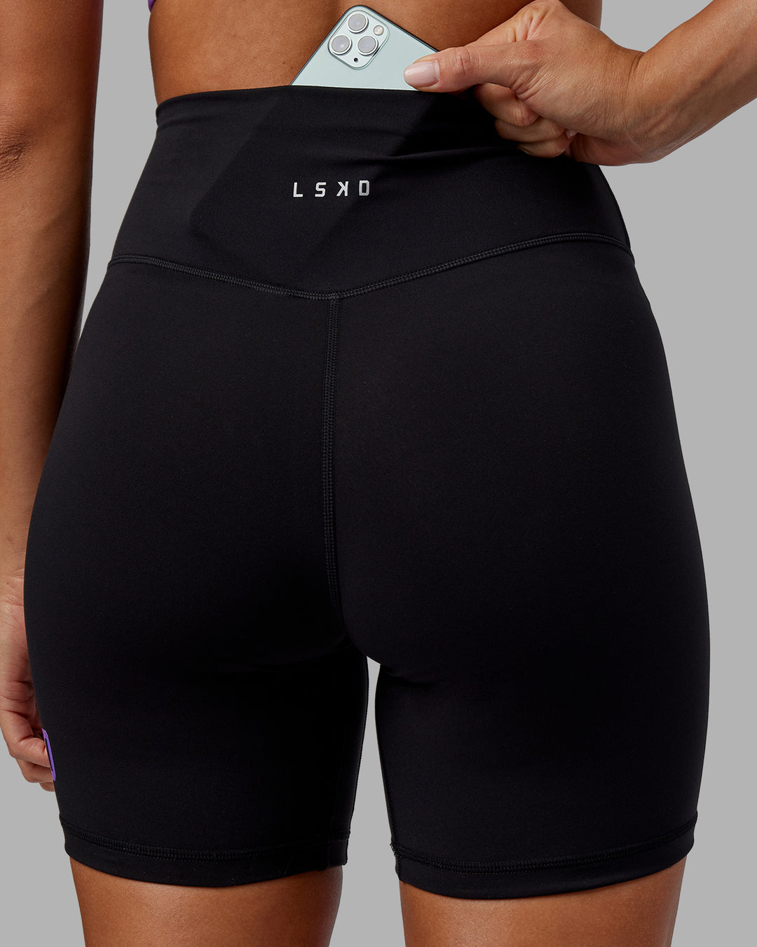 Woman wearing Evolved Ultra High-Rise 6&quot; Short - Black-Purple Swirl