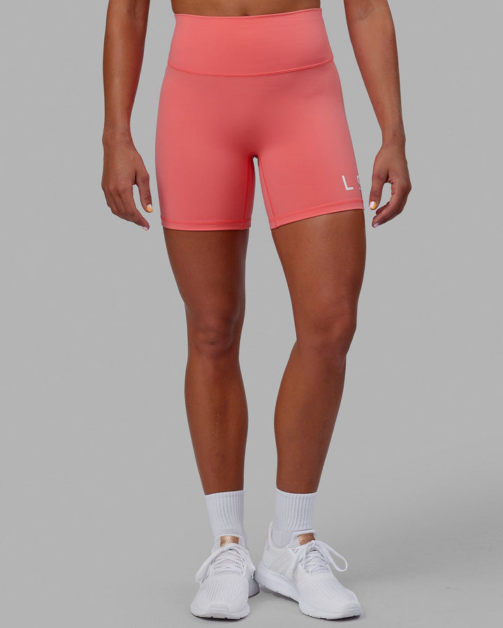 Woman wearing Evolved Mid Short Tight - Coral