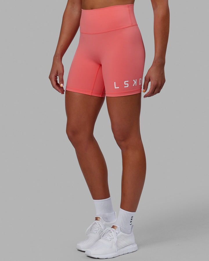 Woman wearing Evolved Mid Short Tight - Coral