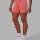 Woman wearing Evolved Mid Short Tight - Coral