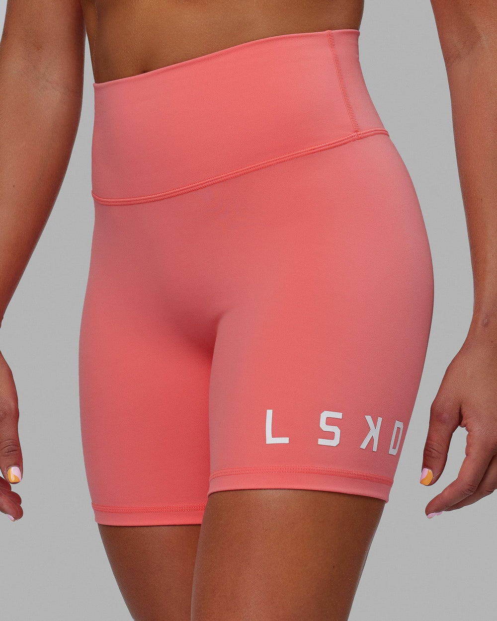 Woman wearing Evolved Mid Short Tight - Coral