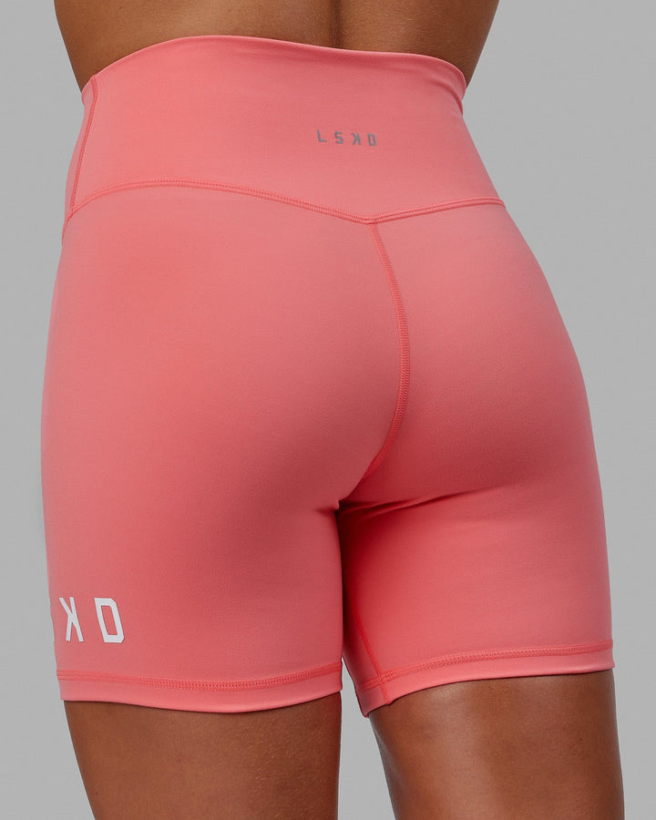 Woman wearing Evolved Mid Short Tight - Coral