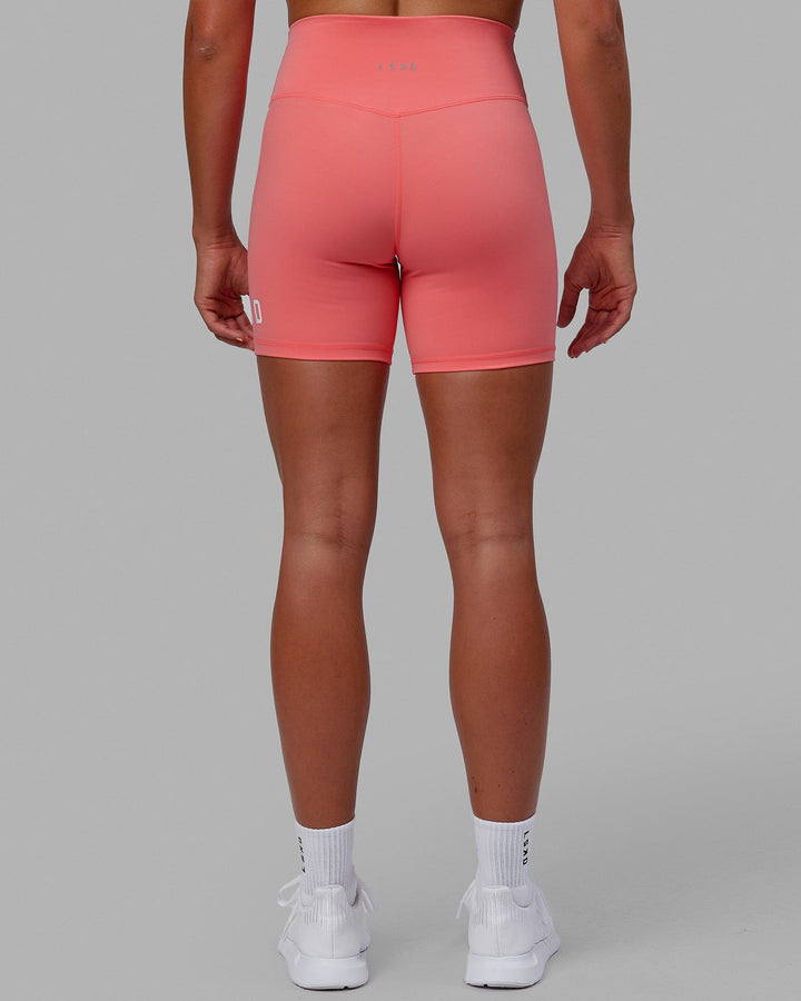 Woman wearing Evolved Mid Short Tight - Coral