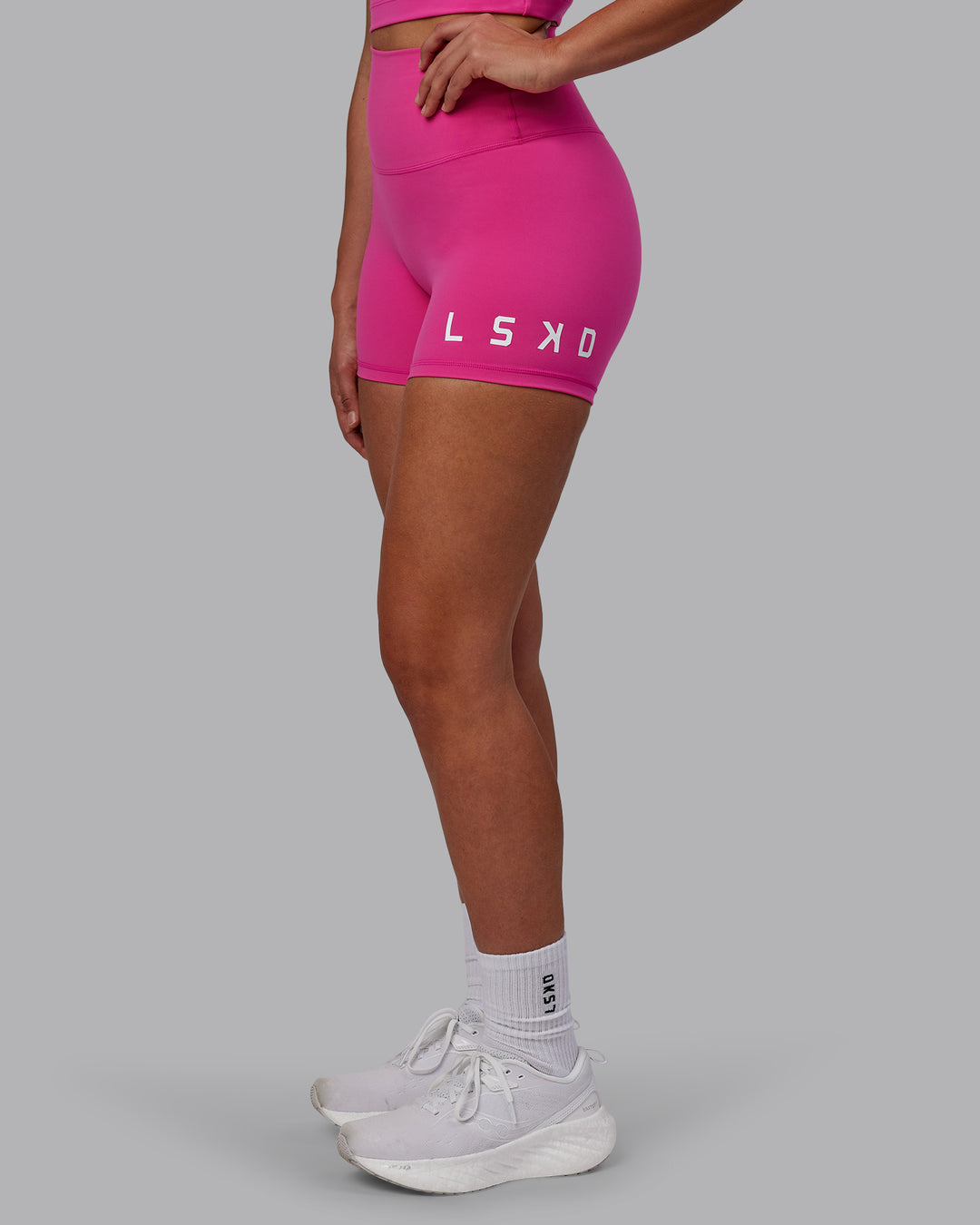 Woman wearing Evolved Ultra High-Rise 4&quot; Short - Fuchsia Pink-White