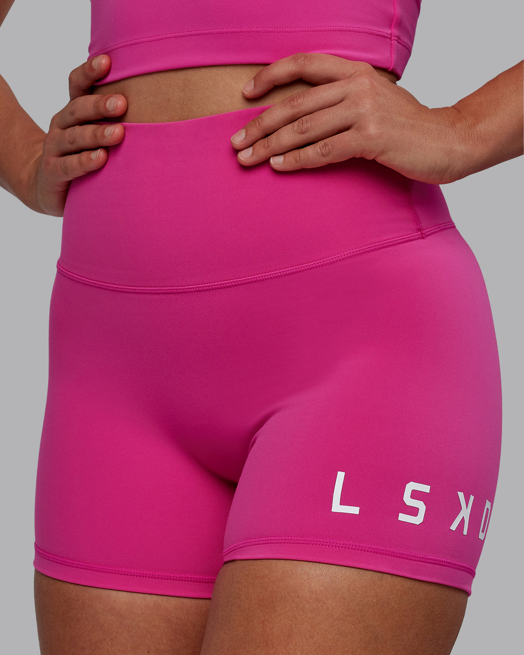 Woman wearing Evolved Ultra High-Rise 4&quot; Short - Fuchsia Pink-White