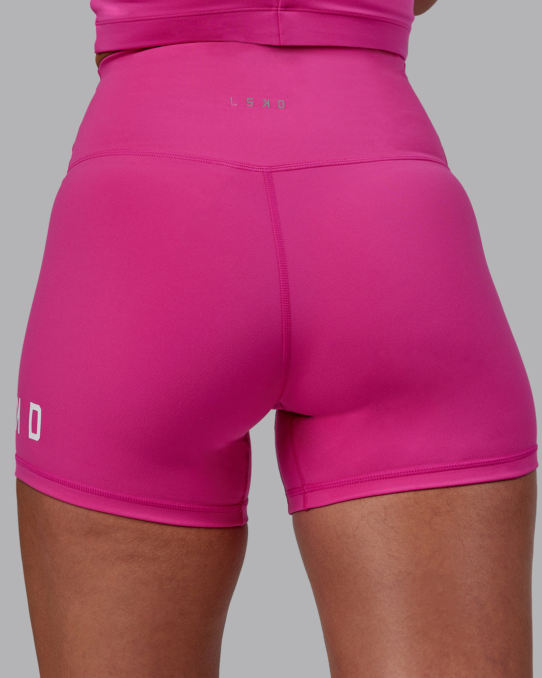Woman wearing Evolved Ultra High-Rise 4&quot; Short - Fuchsia Pink-White