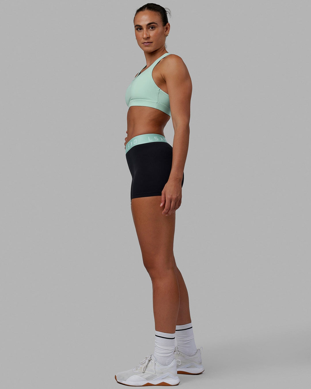 Woman wearing Extend X-Short Tights - Black-Pastel Turquoise