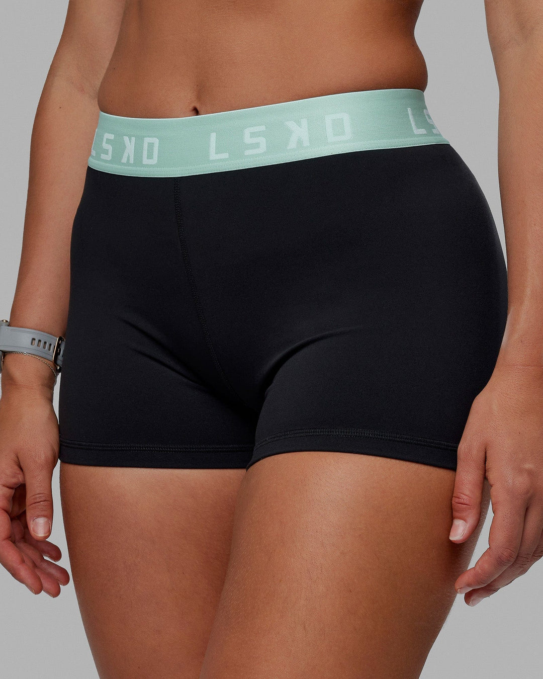 Woman wearing Extend X-Short Tights - Black-Pastel Turquoise