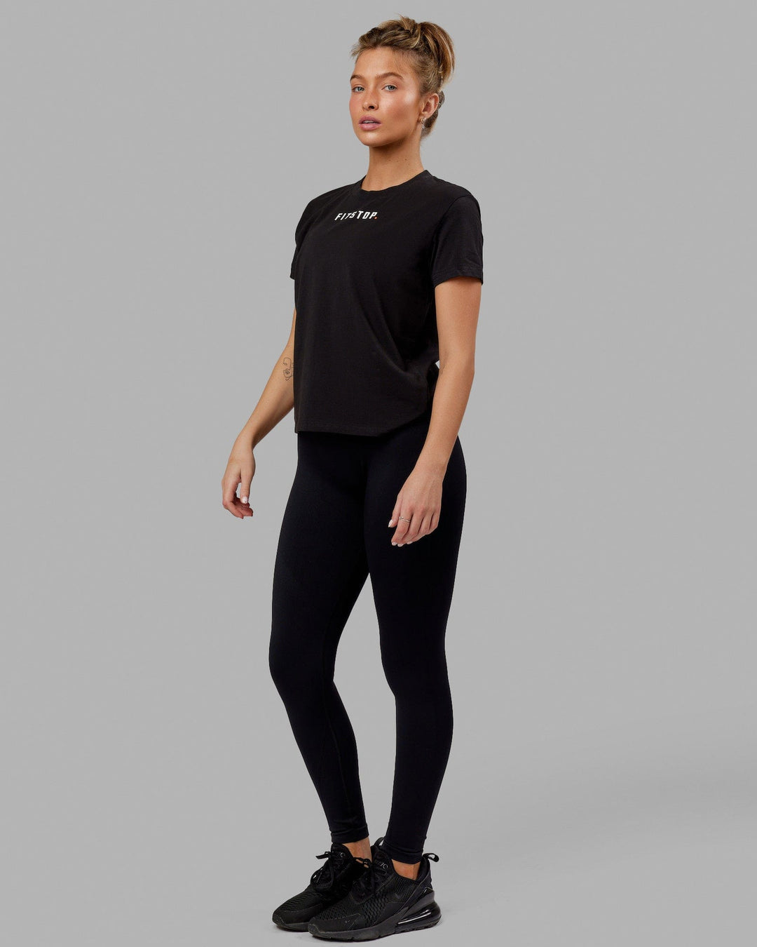 Woman wearing Fitstop Fast Tee - Black