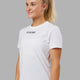Woman wearing Fitstop Fast Tee - White