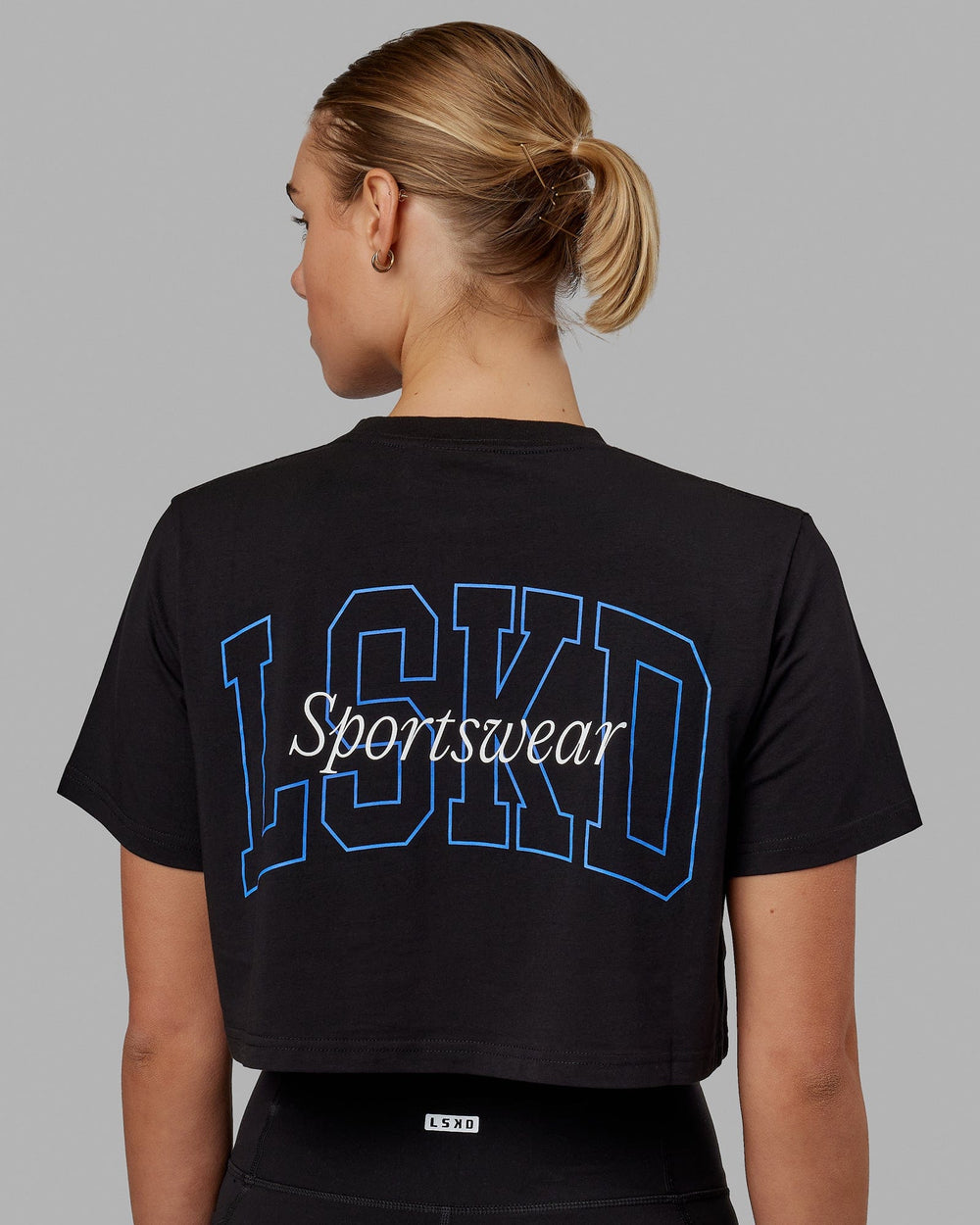 Woman wearing Finish Line Cropped Tee - Black-Power Cobalt
