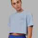 Woman wearing Finish Line Cropped Tee - Windsurfer-Power Cobalt
