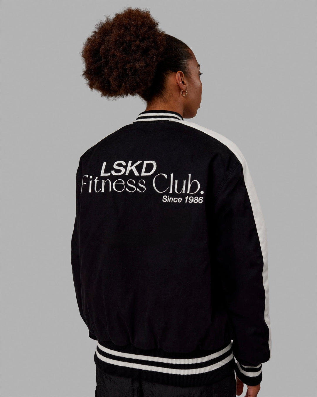 Woman wearing Unisex Fitness Club Bomber Jacket - Black-Off White