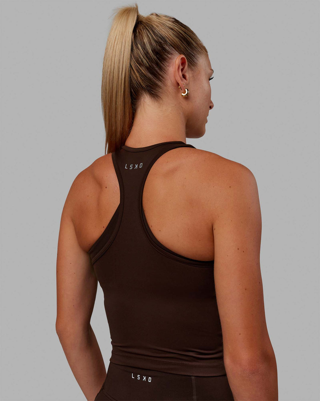 Woman wearing Flow Performance Tank - Dark Chocolate