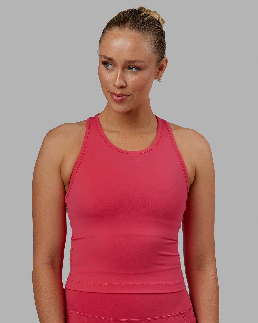 Woman wearing Flow Performance Tank - Raspberry