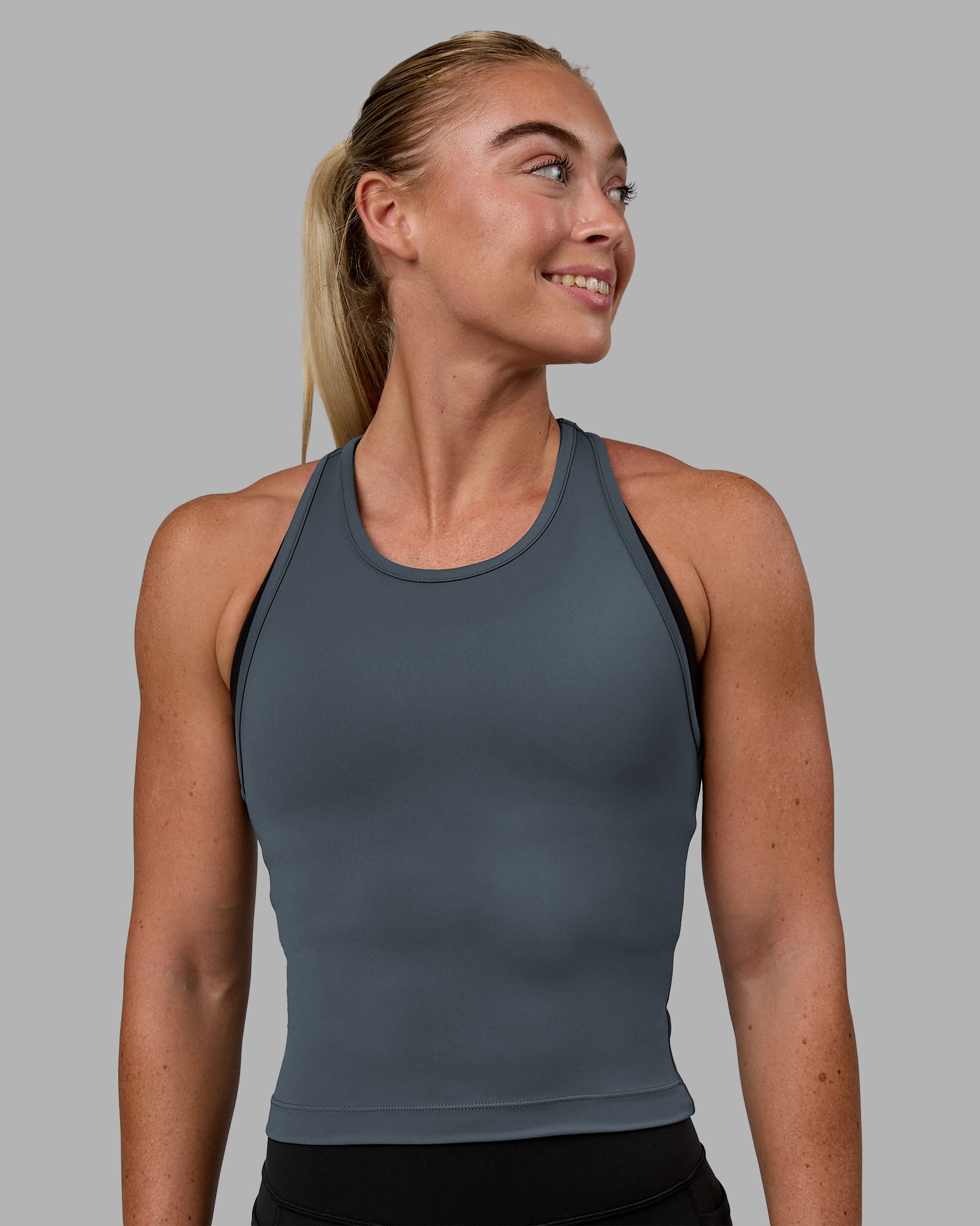 Woman wearing Flow Performance Tank - Turbulence