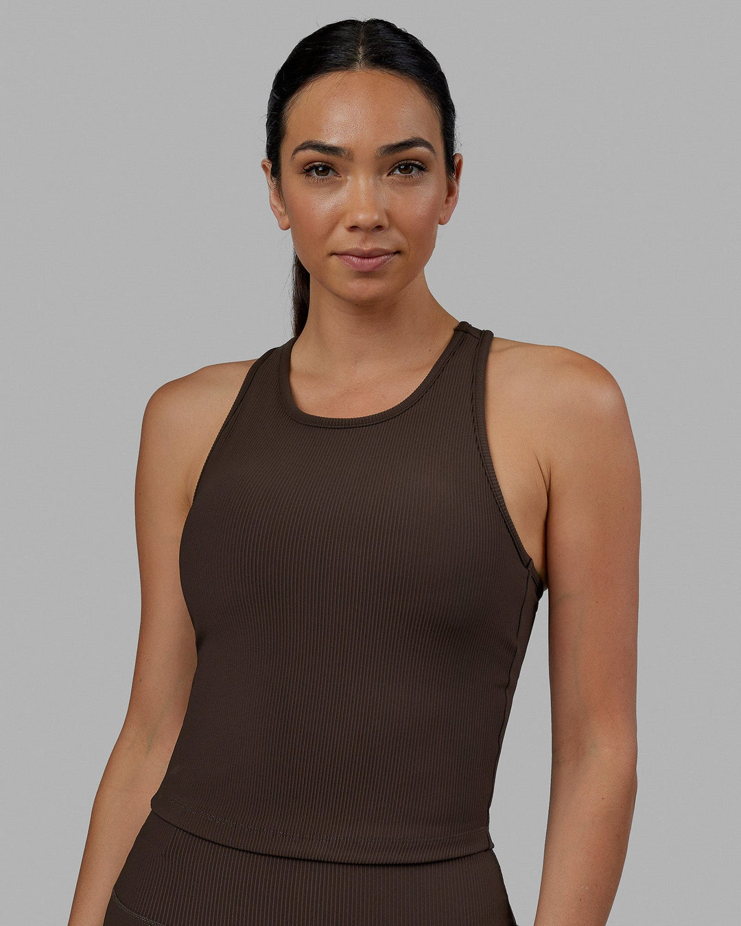 Woman wearing Flow Ribbed Shelf Bra Performance Tank - Dark Chocolate
