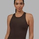 Woman wearing Flow Ribbed Shelf Bra Performance Tank - Dark Chocolate