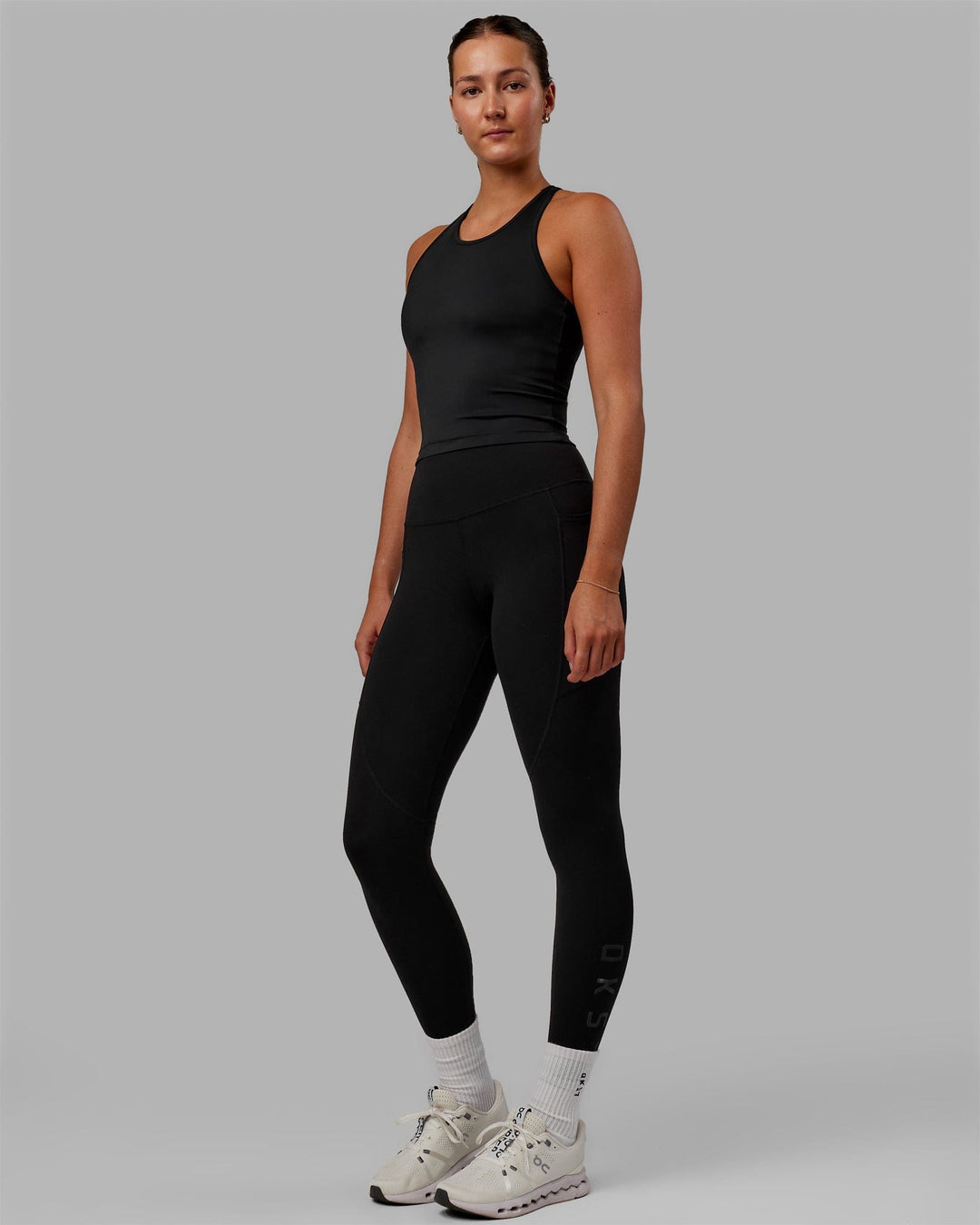 Woman wearing Flow Shelf Bra Performance Tank - Black