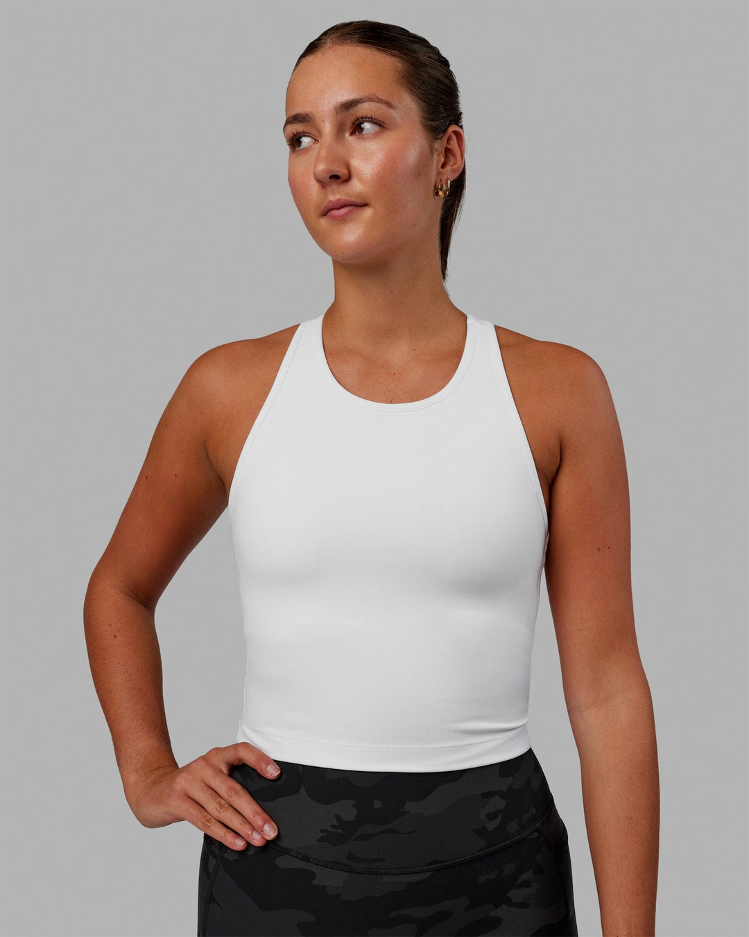 Woman wearing Flow Shelf Bra Performance Tank - White