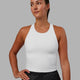Woman wearing Flow Shelf Bra Performance Tank - White