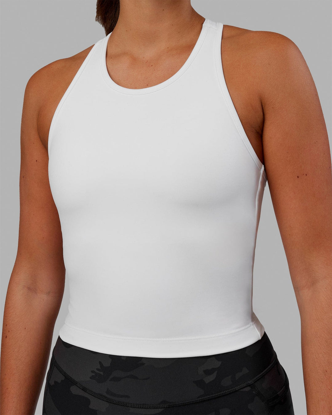 Woman wearing Flow Shelf Bra Performance Tank - White