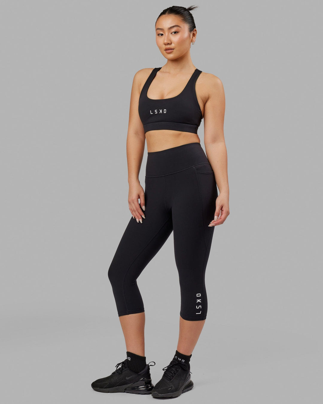 Woman wearing Flux Ultra High-Rise 3/4 Legging Pockets - Black