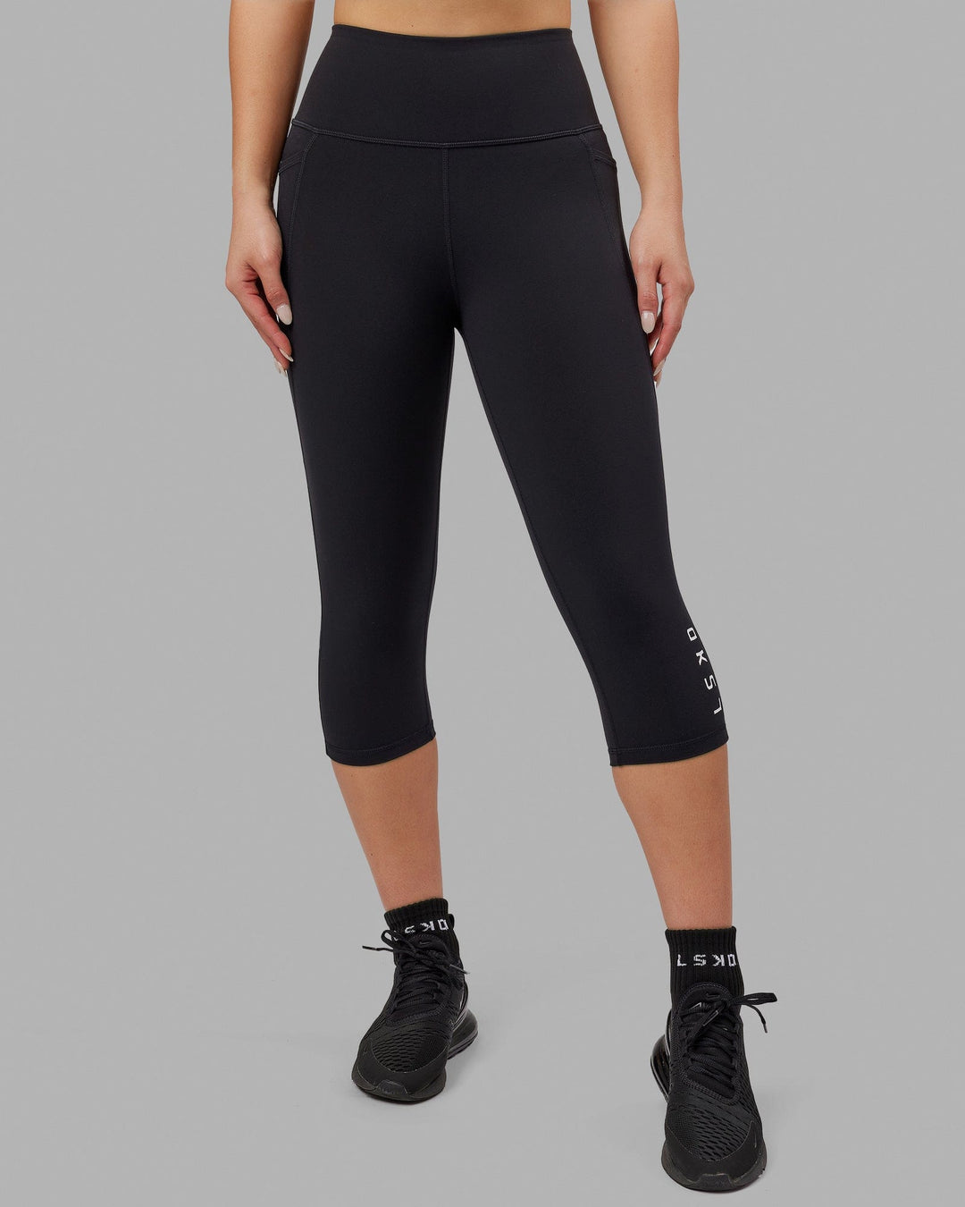 Woman wearing Flux Ultra High-Rise 3/4 Legging Pockets - Black