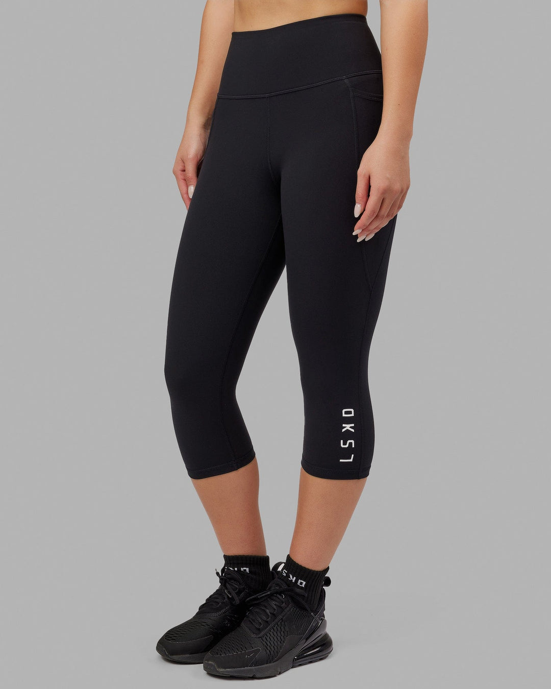Woman wearing Flux Ultra High-Rise 3/4 Legging Pockets - Black