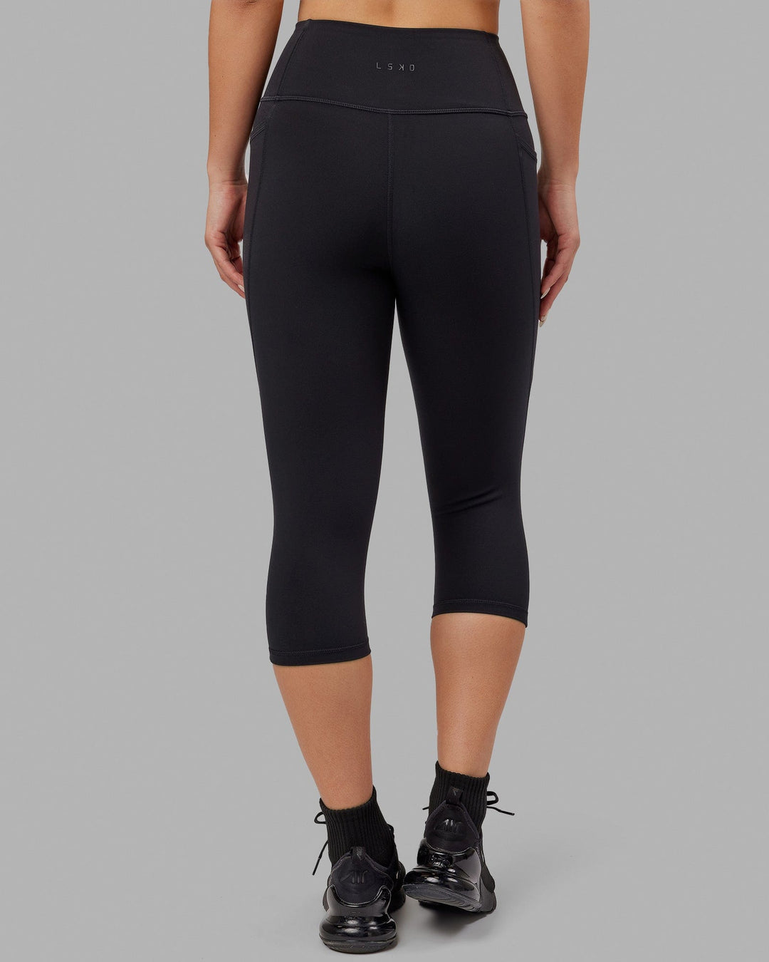 Woman wearing Flux Ultra High-Rise 3/4 Legging Pockets - Black