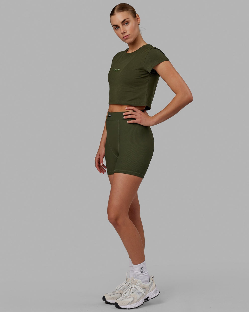 Woman wearing Front Runner Baby Tee - Forest Night