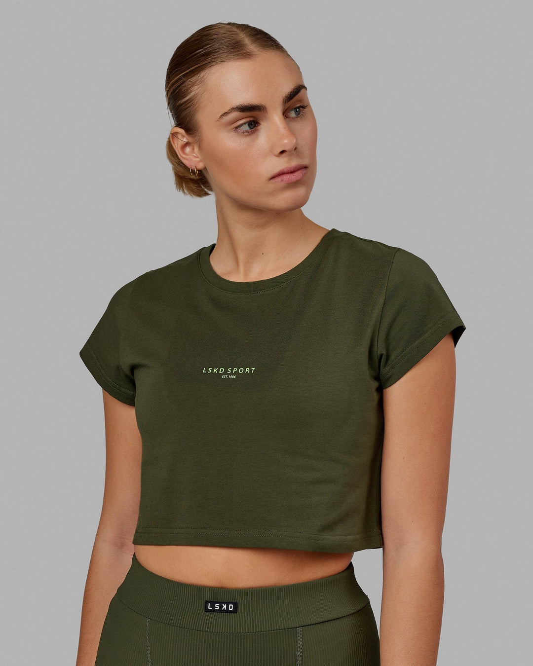 Woman wearing Front Runner Baby Tee - Forest Night