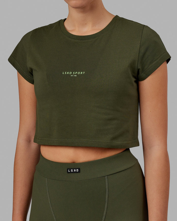 Woman wearing Front Runner Baby Tee - Forest Night