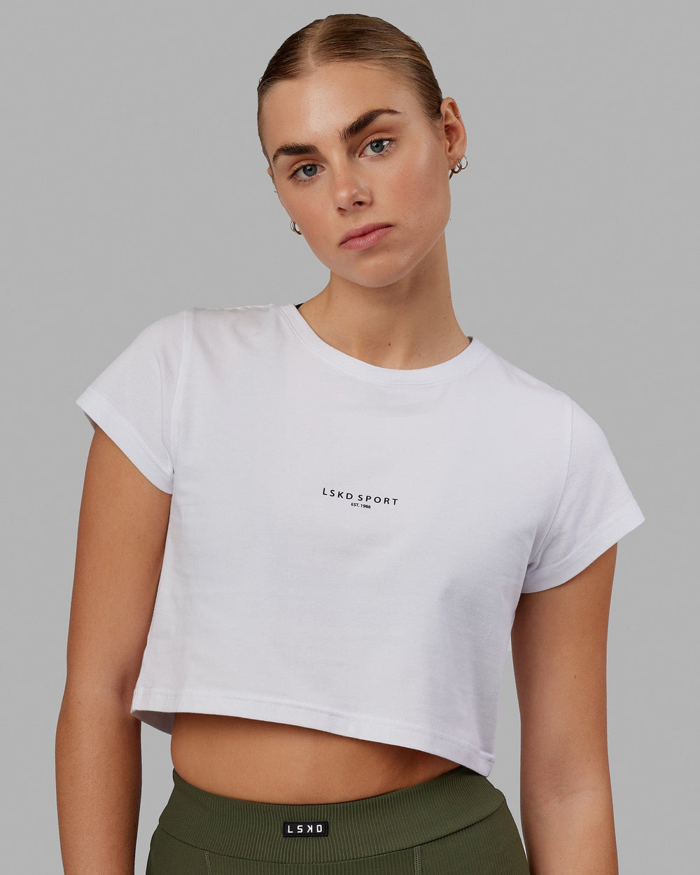Woman wearing Front Runner Baby Tee - White