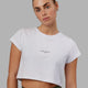 Woman wearing Front Runner Baby Tee - White