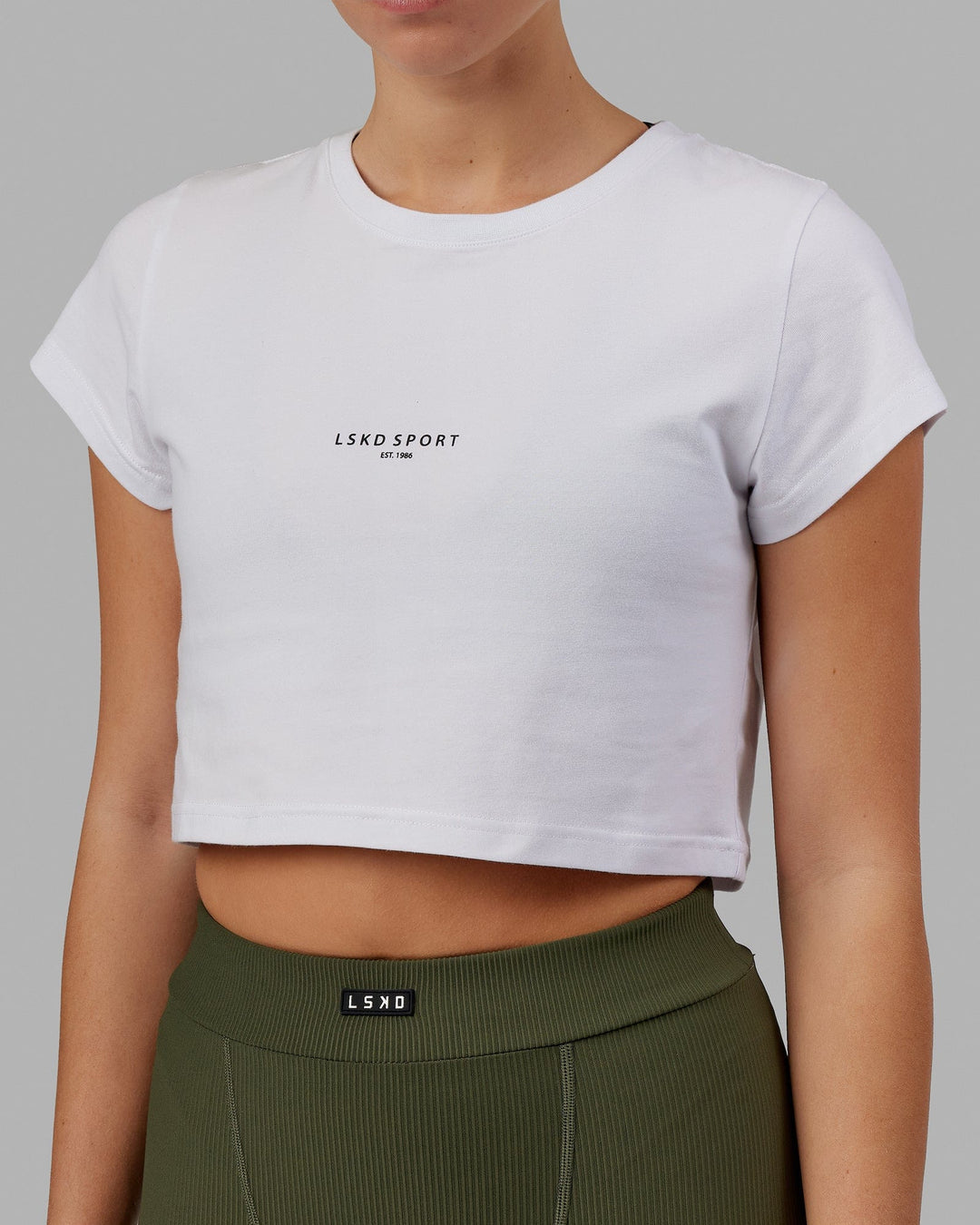 Woman wearing Front Runner Baby Tee - White