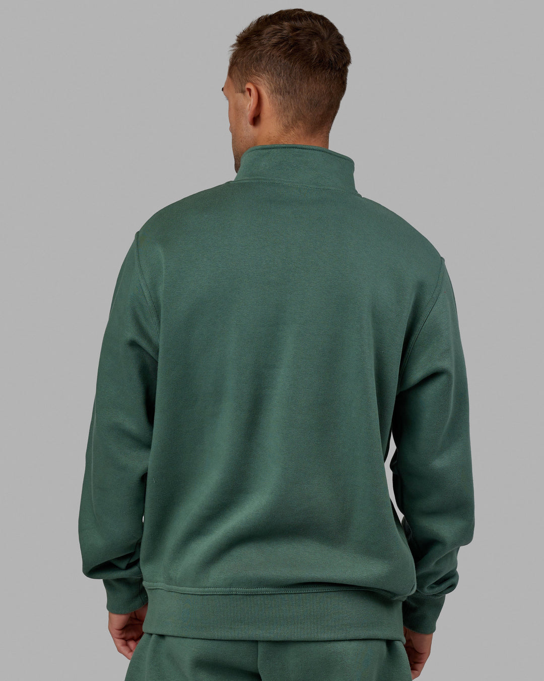 Man wearing Unisex Fundamental 1/4 Zip Sweater - Dark Forest