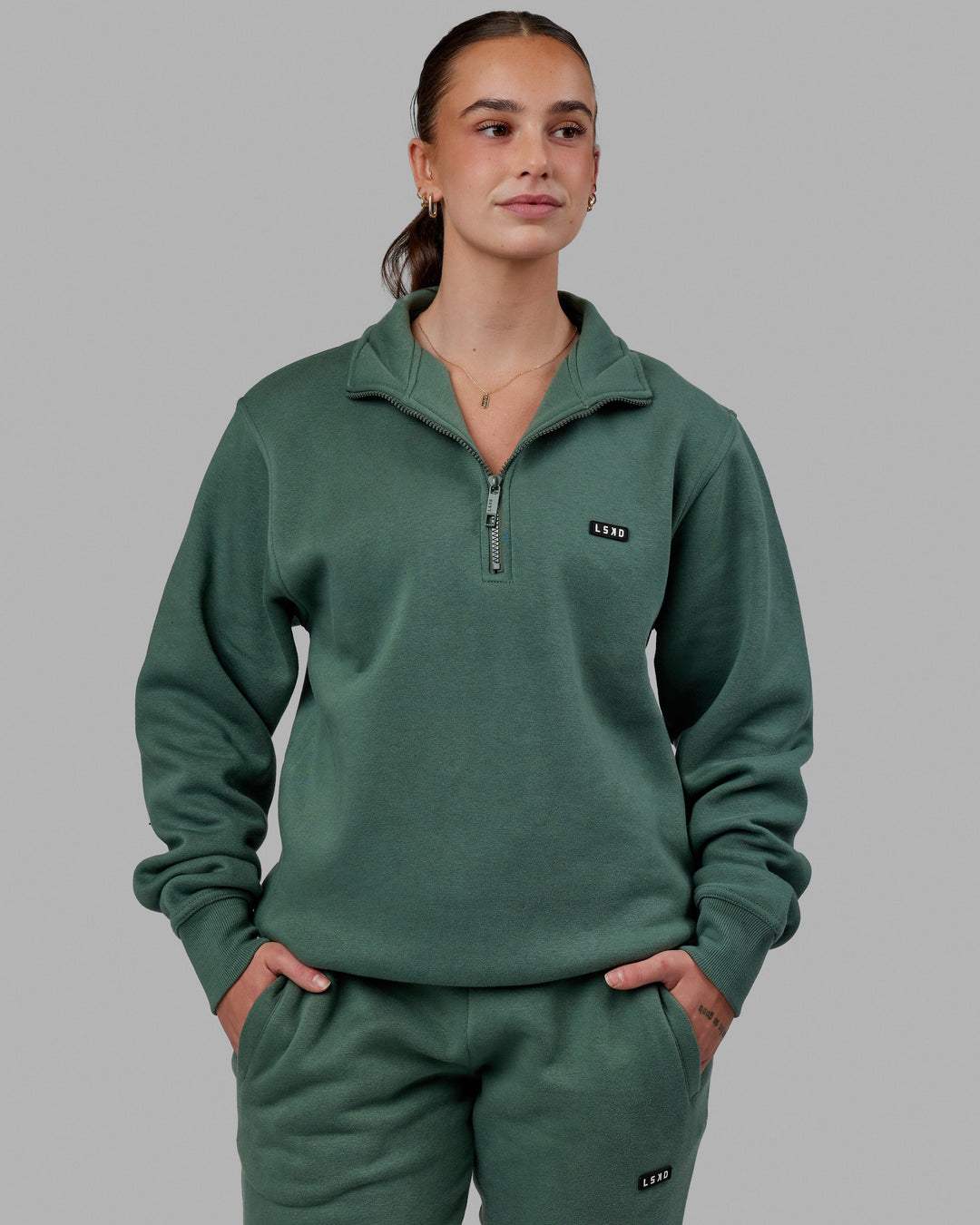 Woman wearing Unisex Fundamental 1/4 Zip Sweater - Dark Forest