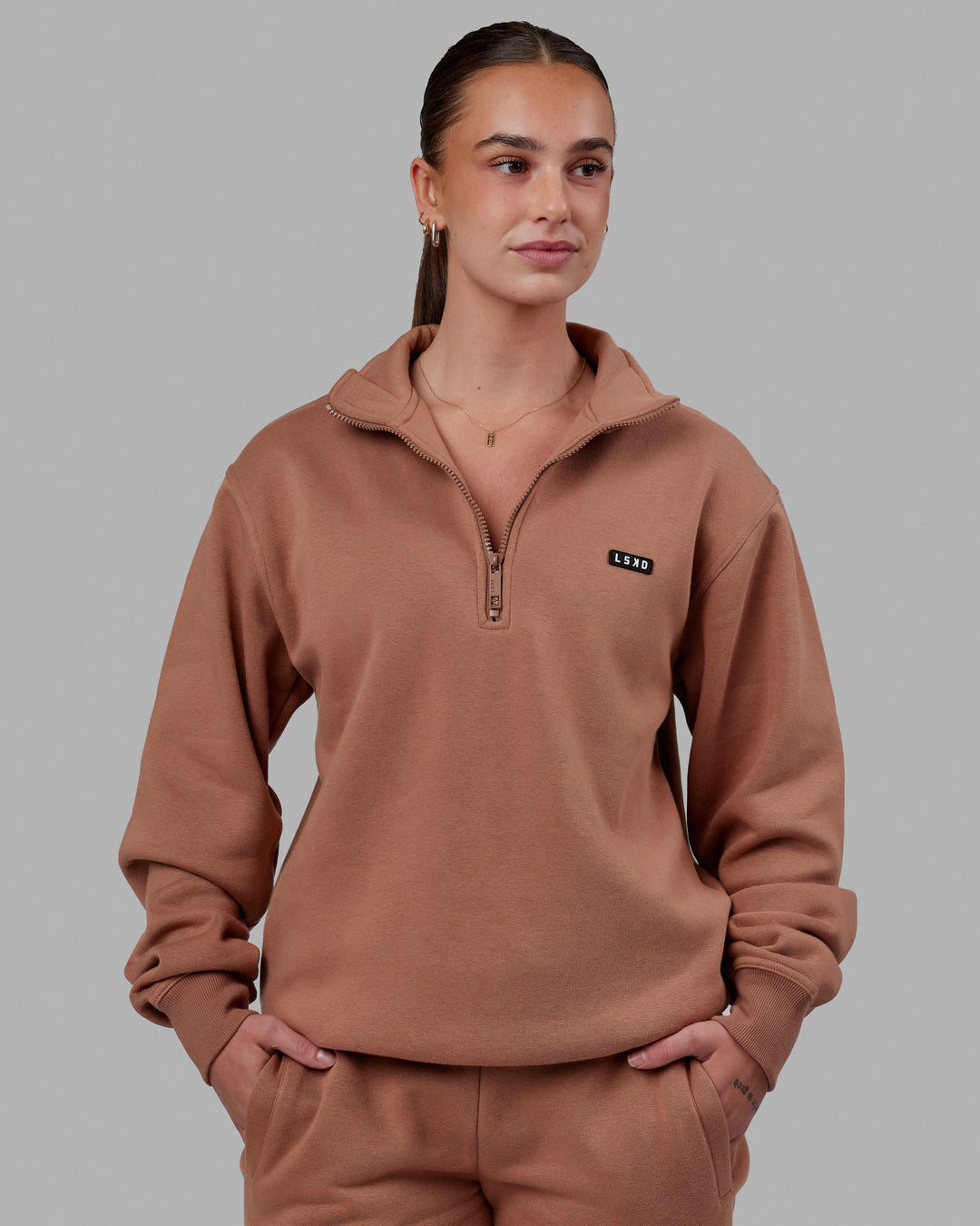 Woman wearing Unisex Fundamental 1/4 Zip Sweater - Raw Umber