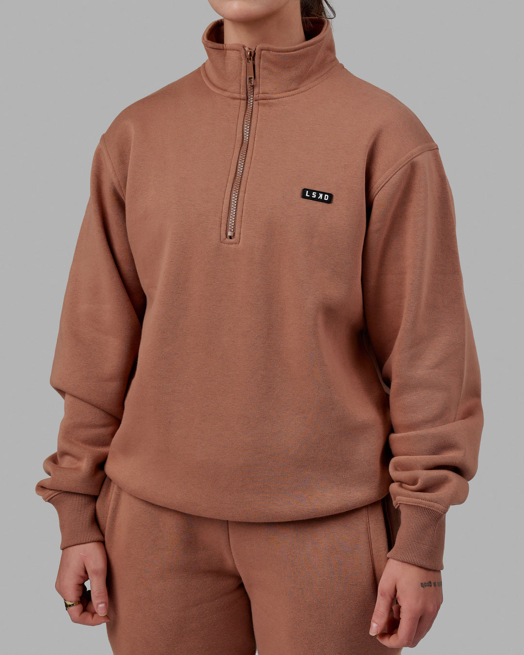Woman wearing Unisex Fundamental 1/4 Zip Sweater - Raw Umber
