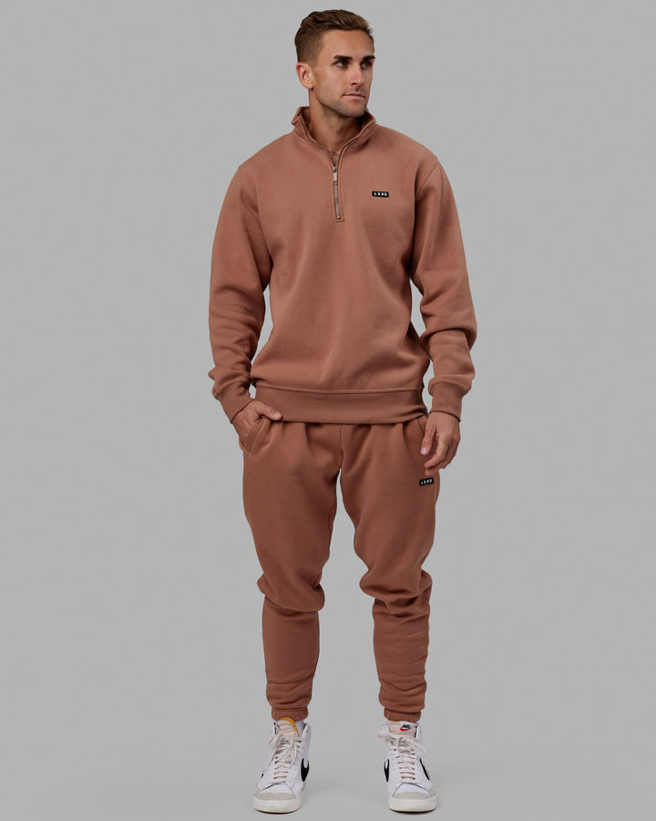 Man wearing Unisex Fundamental 1/4 Zip Sweater - Raw Umber